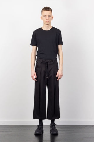 Shop Emerging Alternative Fashion Unisex Street Brand Monochrome AW22 Black Cropped Leg Inverted Denim Trousers at Erebus