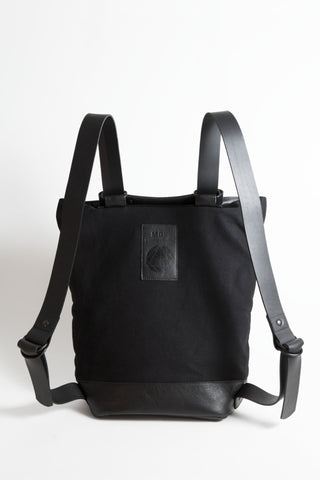 Shop Emerging Conscious Avant-garde Designer Brand MDK Miranda Kaloudis Black Nappa Leather and Waxed Cotton Canvas Transformable Tesris Backpack Bag at Erebus